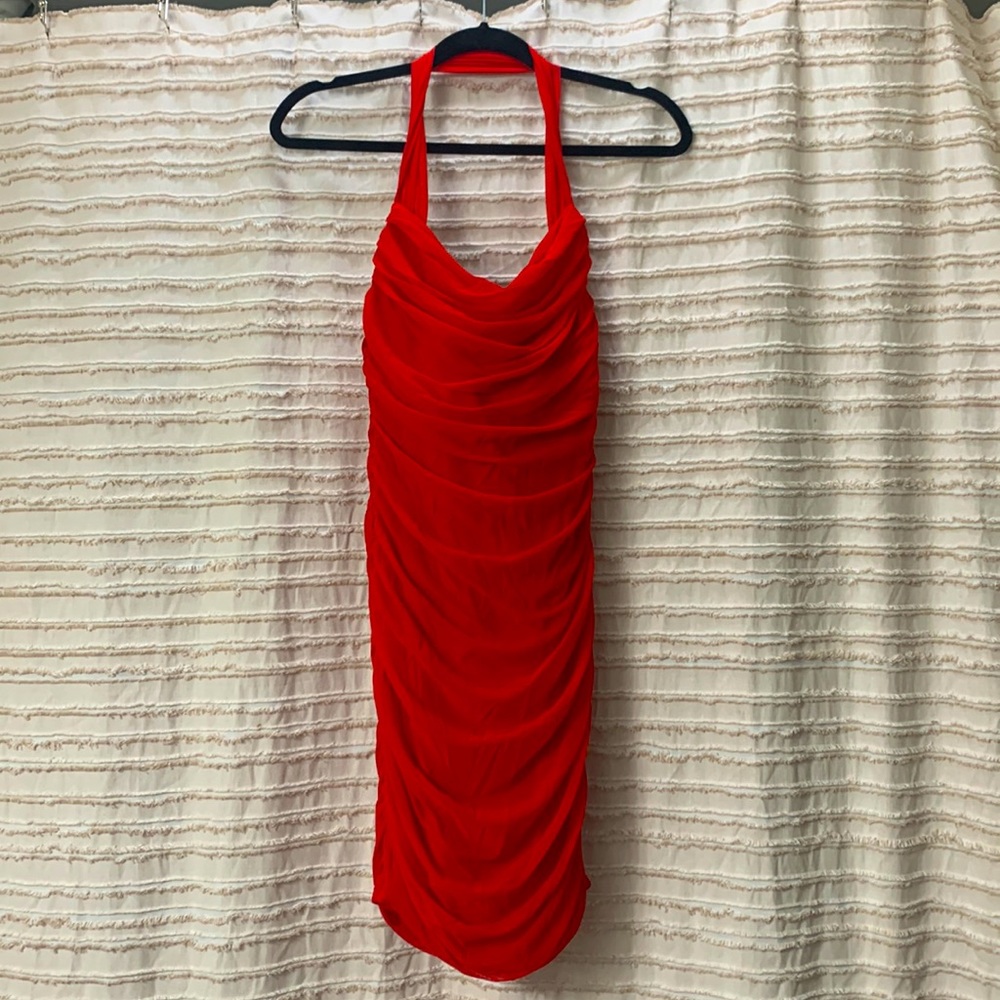 Fiery red stretchy cocktail dress with halter neckline.